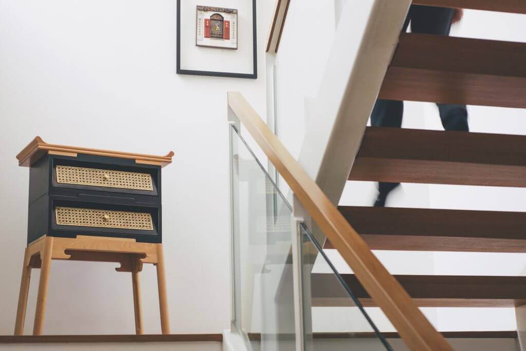 Drawer chest on staircase landing with frame on wall
