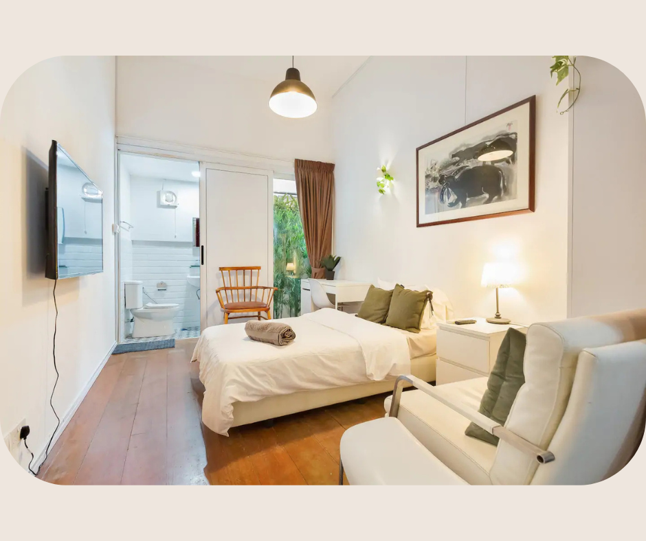 Private ensuite room at Red Dragon House for boutique coliving in Singapore, featuring modern heritage design and natural light.