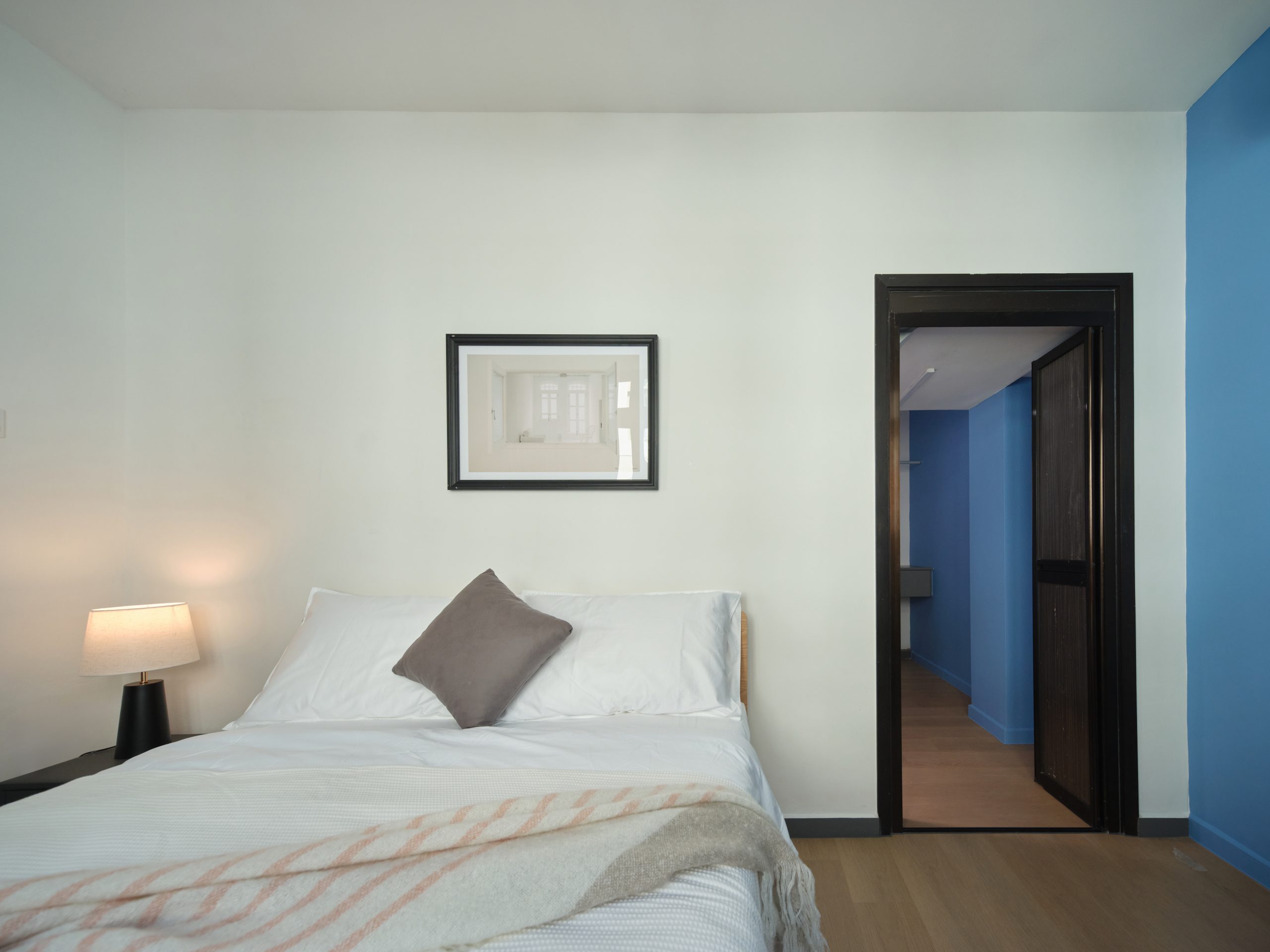 Air-conditioned guest room at Wah Leong House, Figment’s heritage co-living shophouse in Jalan Besar, Singapore