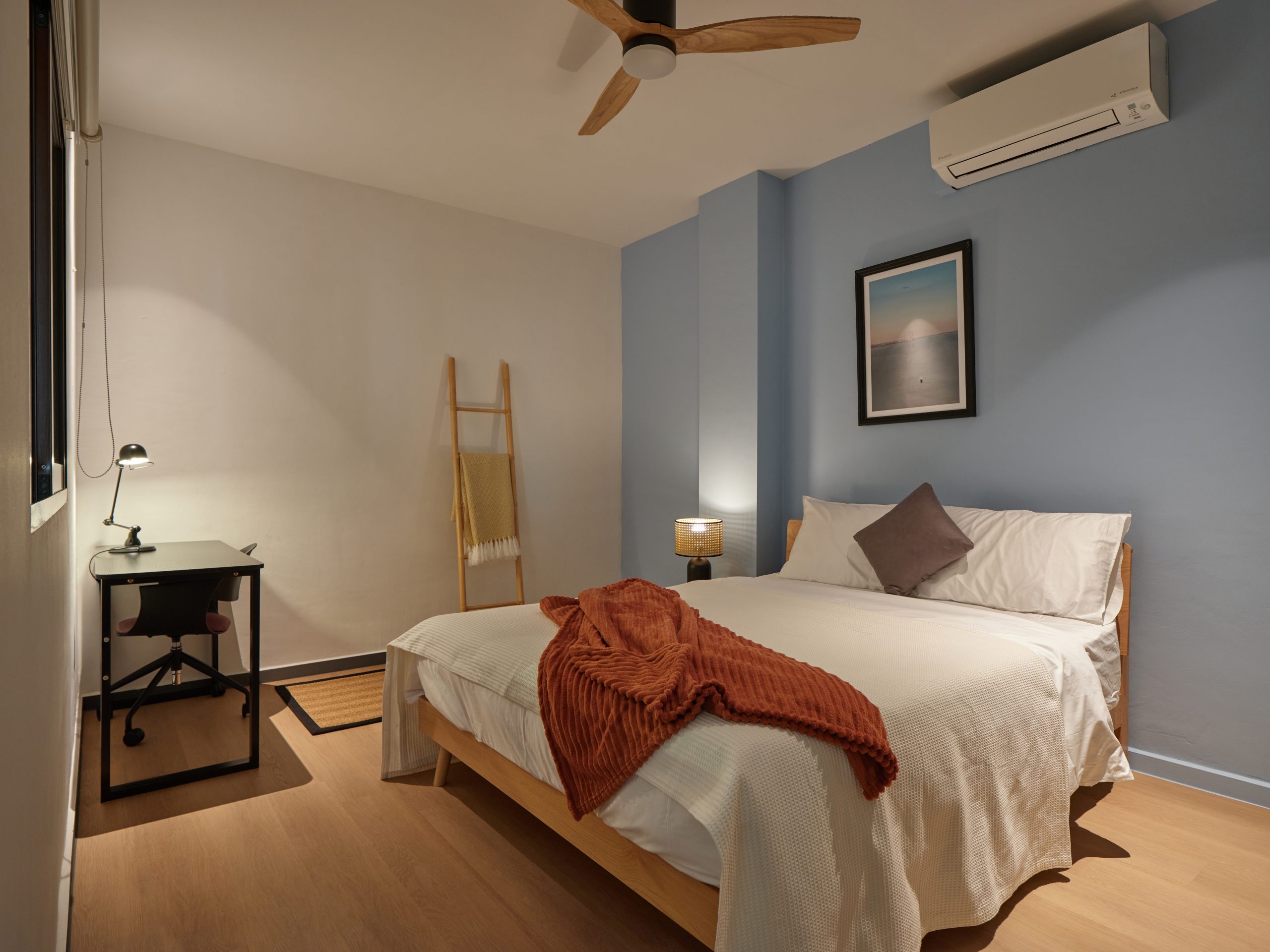 A serene furnished bedroom with warm lighting in a Figment heritage residence in Singapore