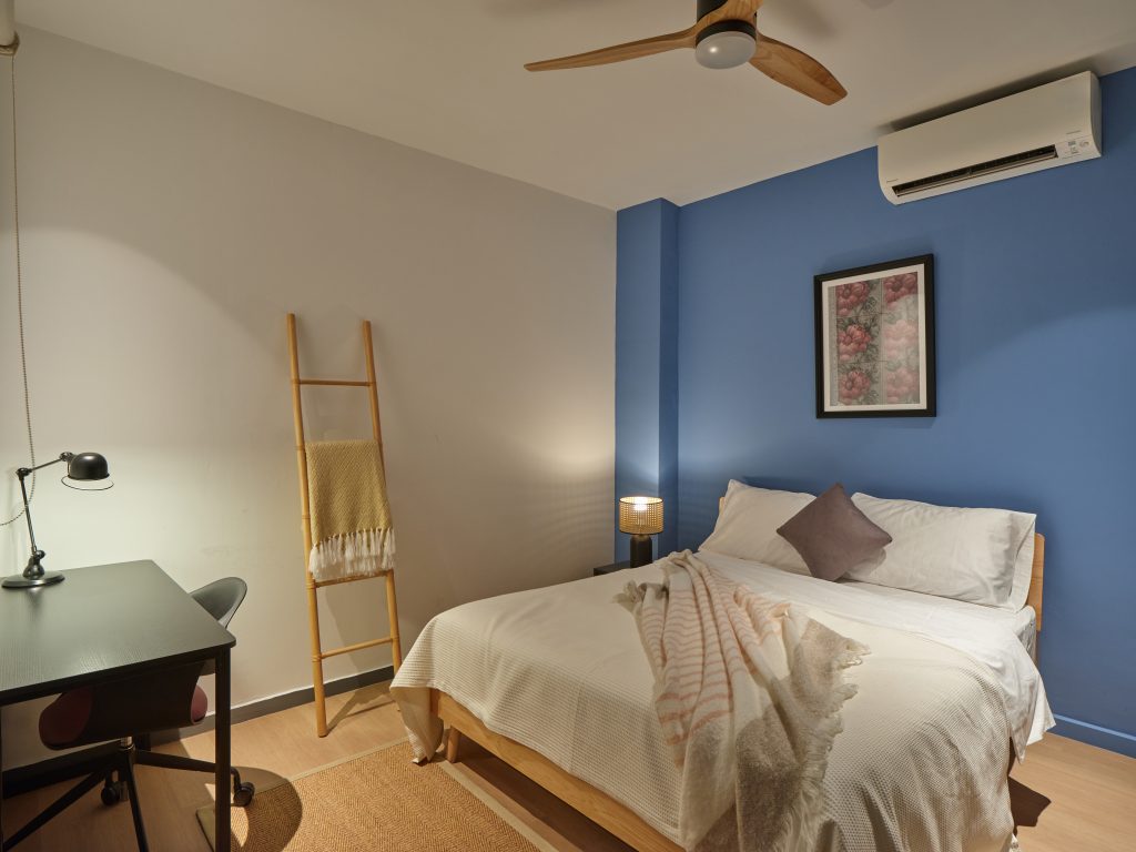 Furnished bedroom in a Figment co-living shophouse suited to a monthly stay